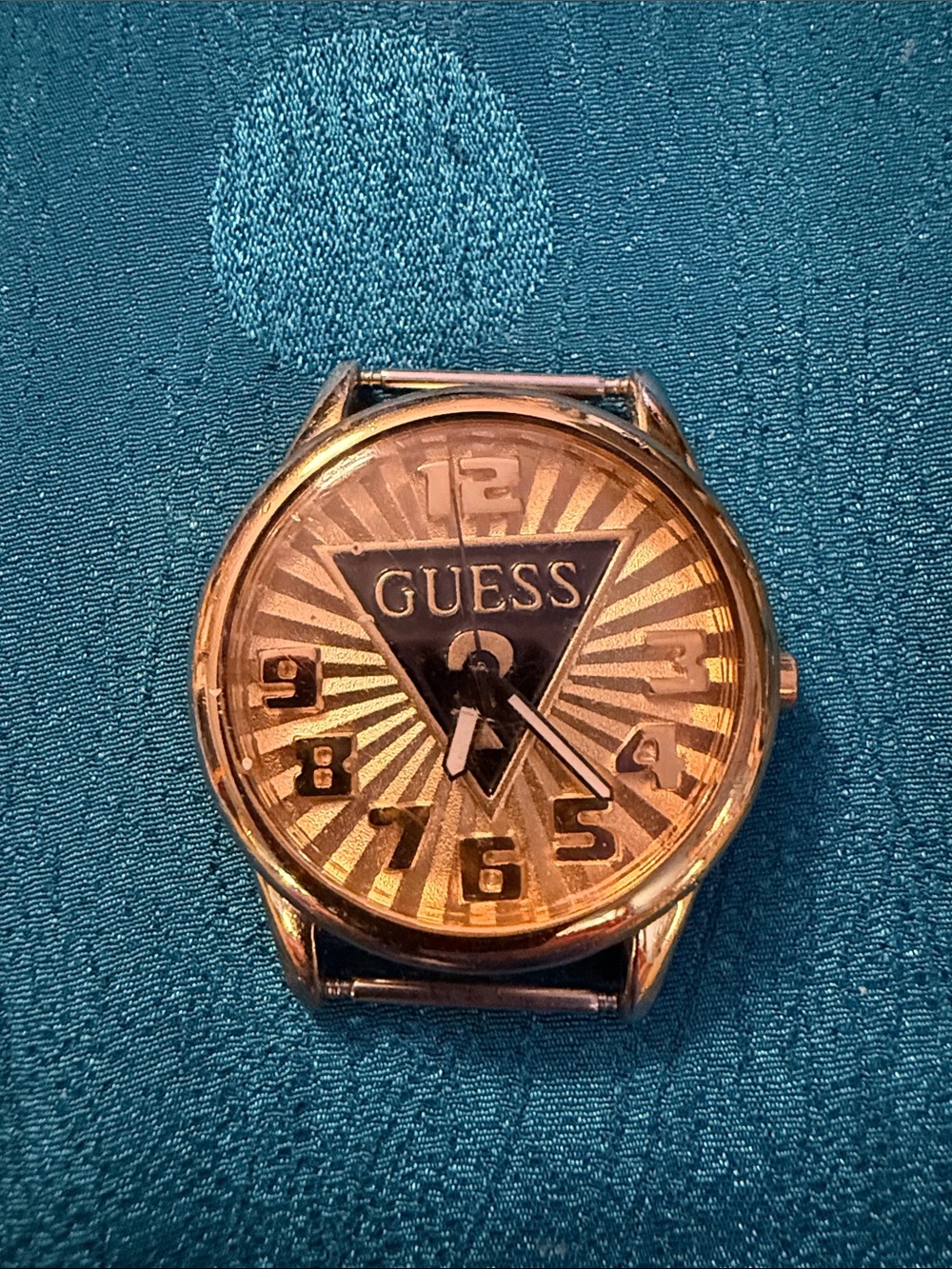 GUESS Men's Gold-Tone Sunburst Dial Watch Face with Black Logo needs band